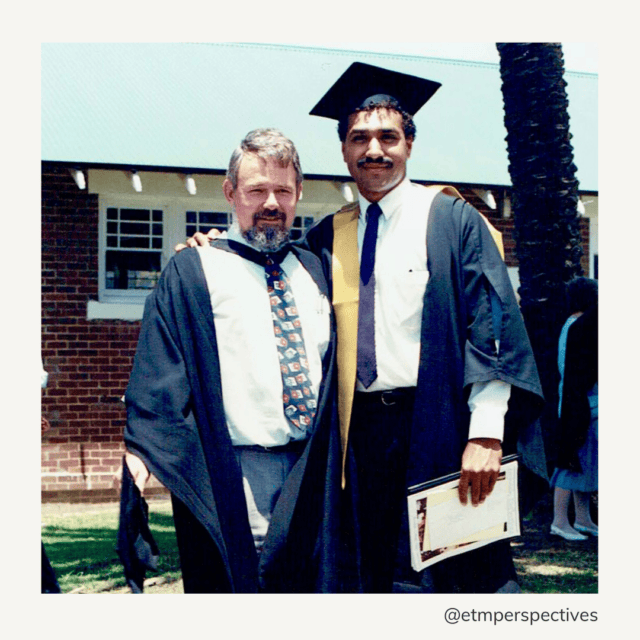 Cedric Greive in academic robes standing with Duane Vickery at his graduation